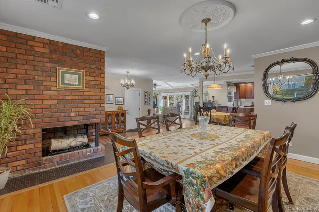 a dining room with a wooden table and chairs