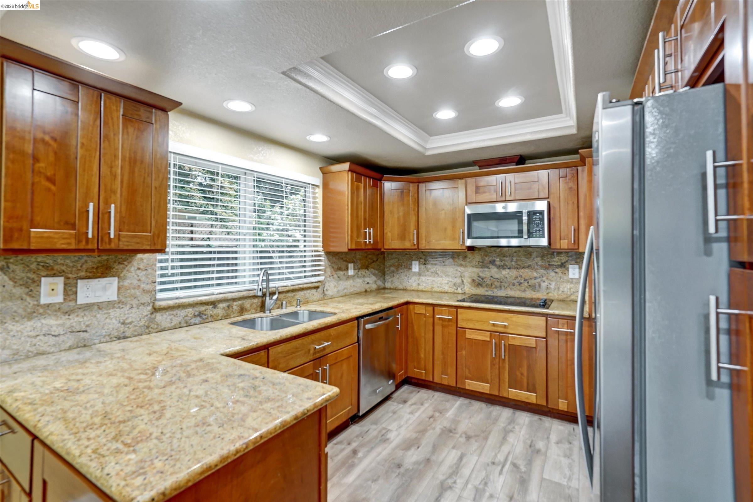 108 Castleton Court San Ramon, CA 94583 - Photo 13 of 41 Kitchen featuring wood finish cabinets, stainless steel appliances, crown molding, light wood finished floors, and recessed lighting