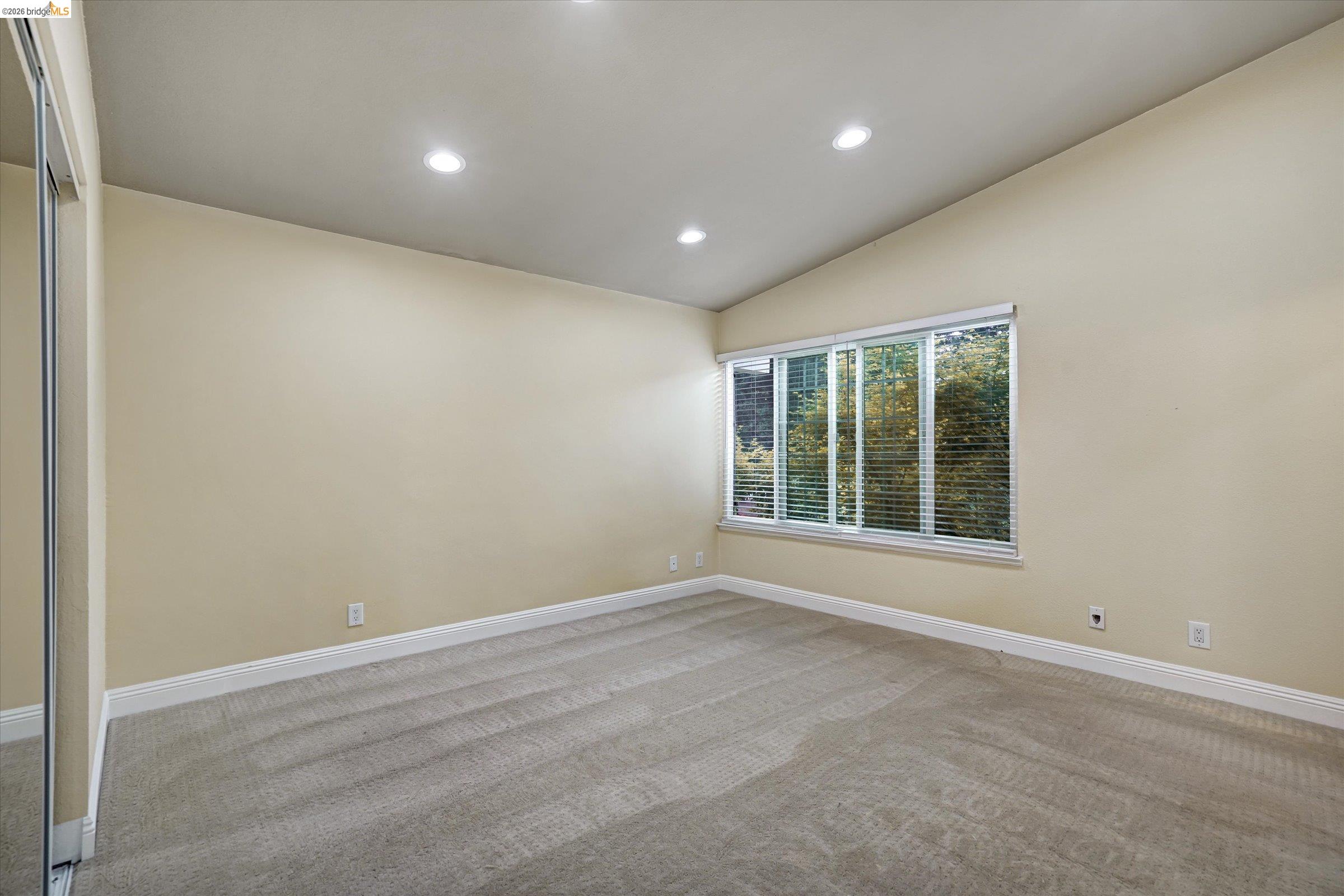 108 Castleton Court San Ramon, CA 94583 - Photo 21 of 41 Empty room with recessed lighting, light carpet, and vaulted ceiling