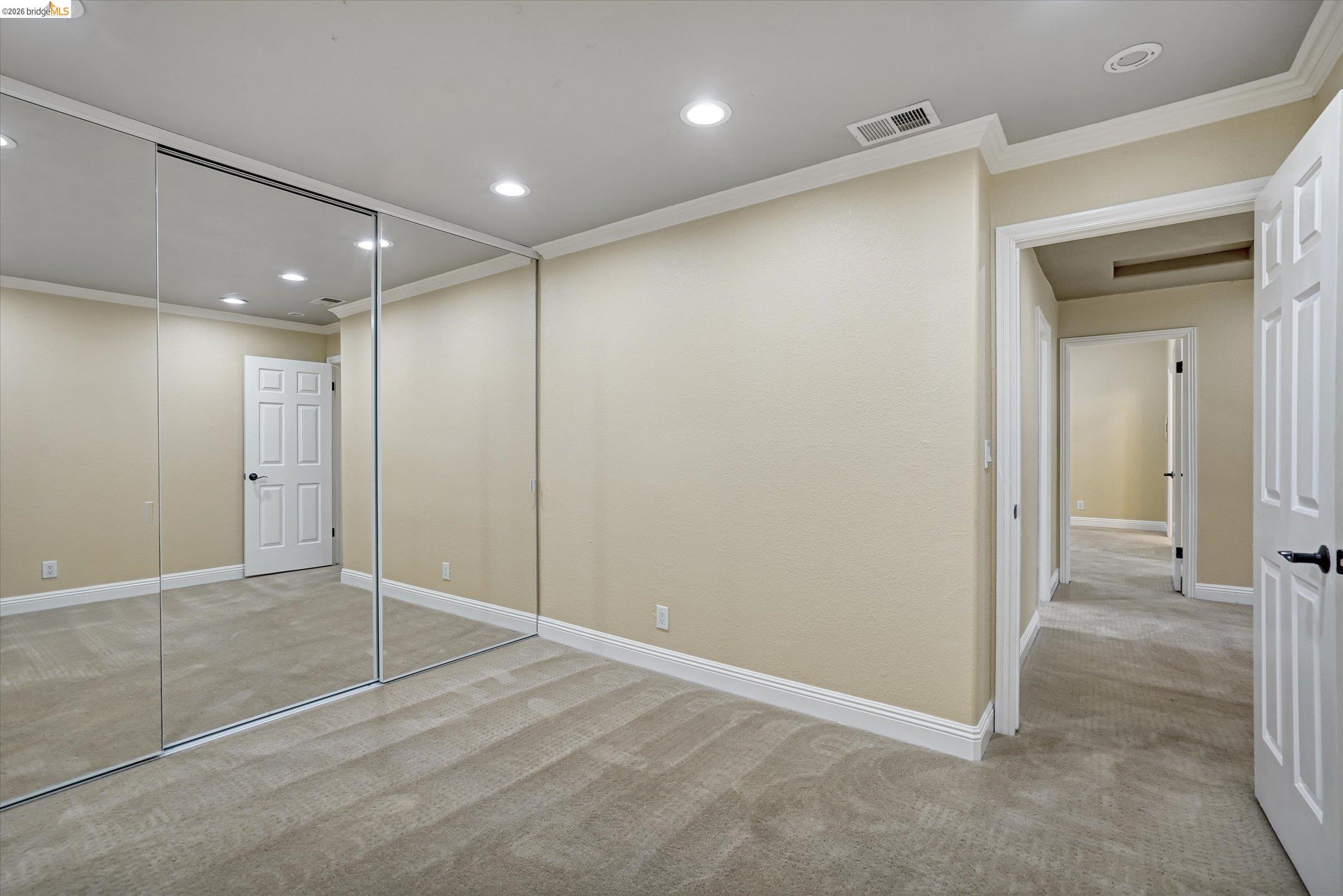 108 Castleton Court San Ramon, CA 94583 - Photo 32 of 41 Unfurnished bedroom featuring crown molding, light carpet, recessed lighting, and a closet