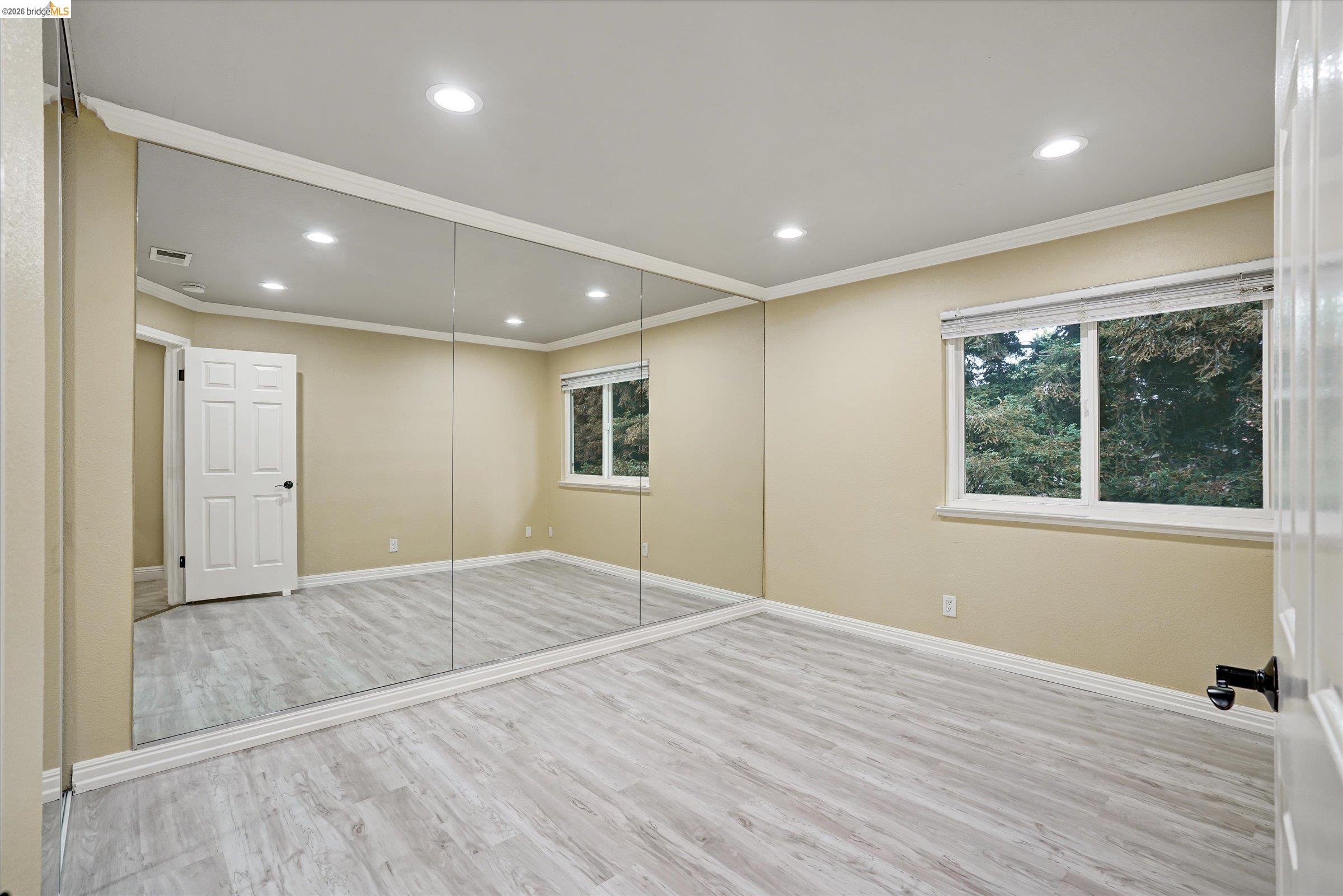 108 Castleton Court San Ramon, CA 94583 - Photo 34 of 41 Unfurnished bedroom featuring light wood finished floors, recessed lighting, crown molding, and multiple windows