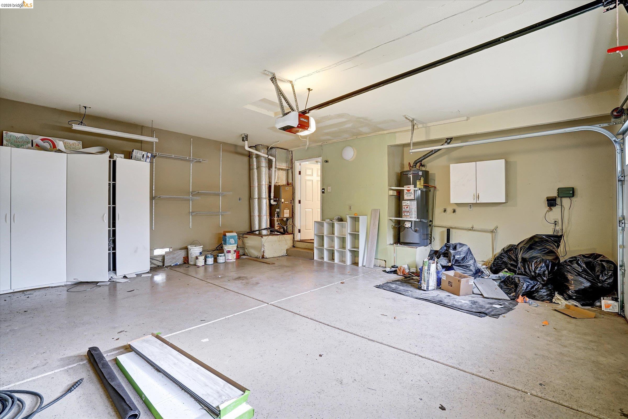 108 Castleton Court San Ramon, CA 94583 - Photo 36 of 41 Garage with secured water heater, heating unit, and a garage door opener