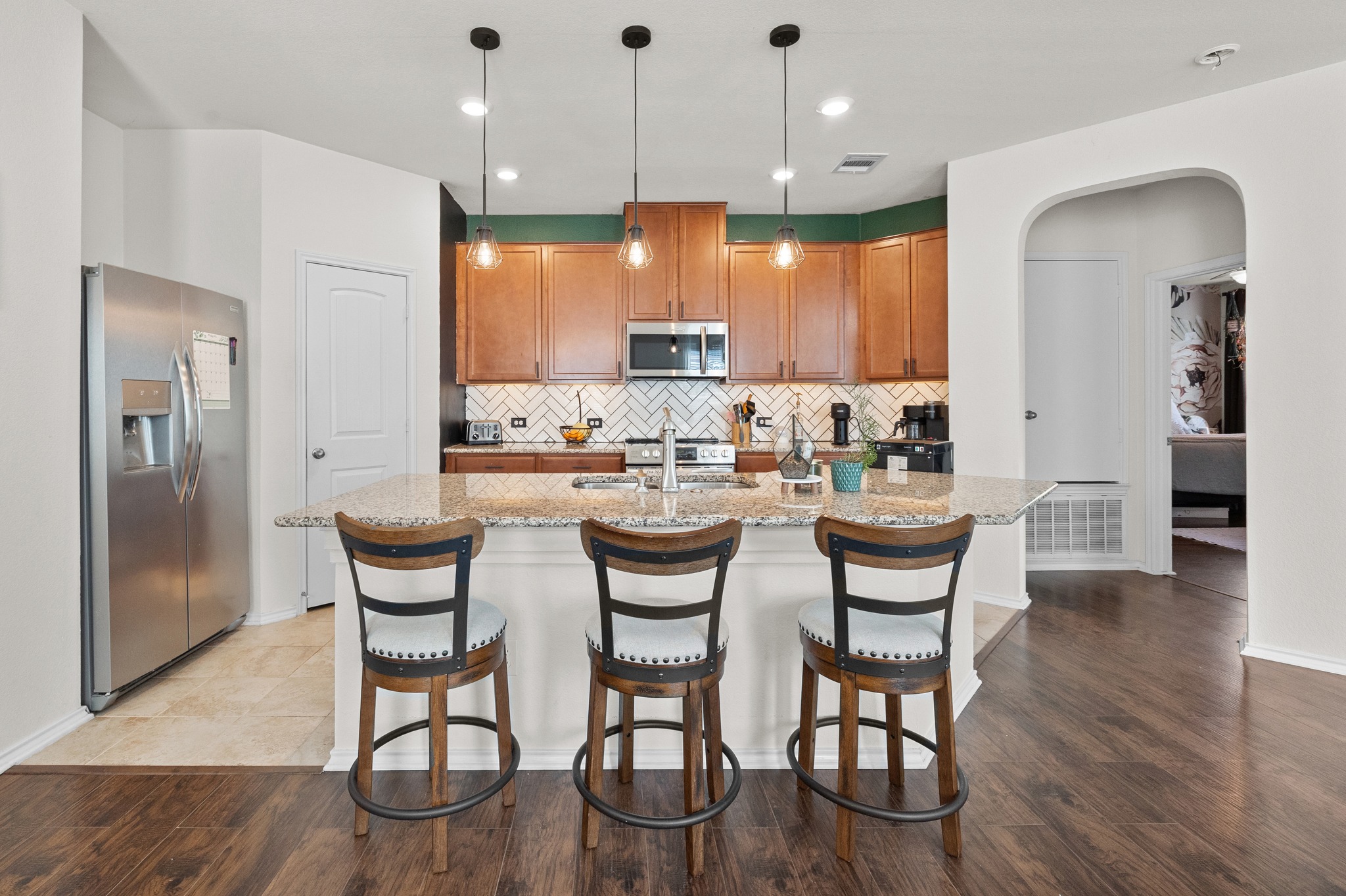 2471 Sunrise Road, Unit 40 Round Rock, TX 78664 - Photo 5 of 22 Rich wood floors meet custom tile work in this inviting kitchen.