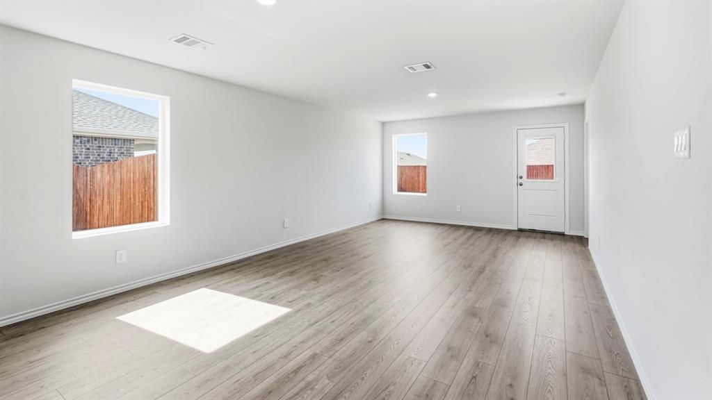 3319 Twilight Trail Forney, TX 75126 - Photo 9 of 33 Spacious room featuring wood-finish flooring, recessed lighting, and a neutral color palette