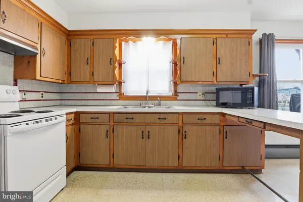 a kitchen with stainless steel appliances granite countertop a sink and a cabinets