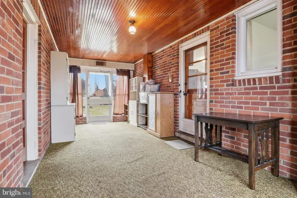 a view of a porch with a table and chairs