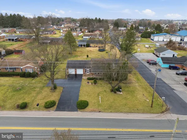 an aerial view of residential house with pool and yard