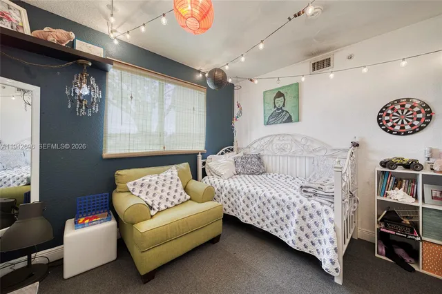 a bedroom with furniture and a large window