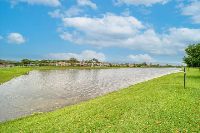 a view of a lake with houses in the back