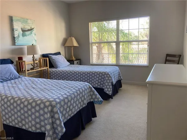 a bedroom with bed and window