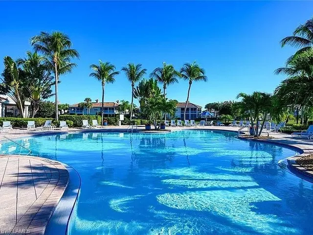 a view of a swimming pool with lounge chairs