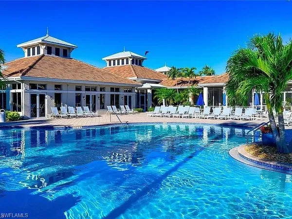 a front view of a house with swimming pool yard and outdoor seating