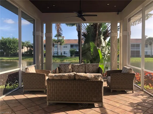 a living room with patio furniture and garden view