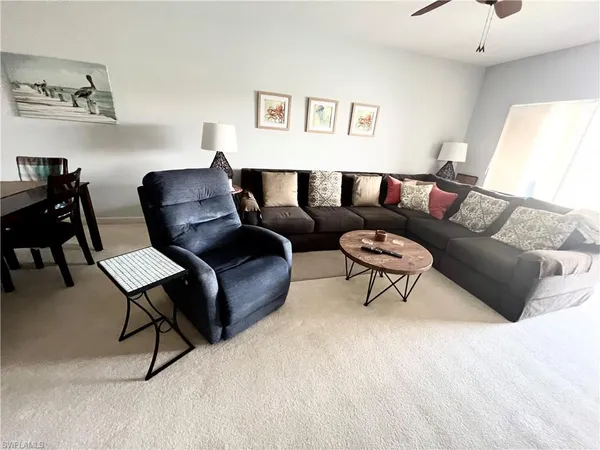 a living room with furniture and a night stand