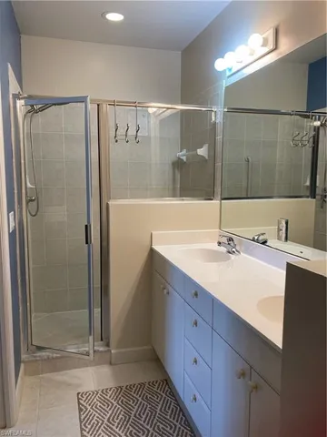 a bathroom with a shower sink and mirror