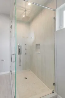a bathroom with a shower and a sink