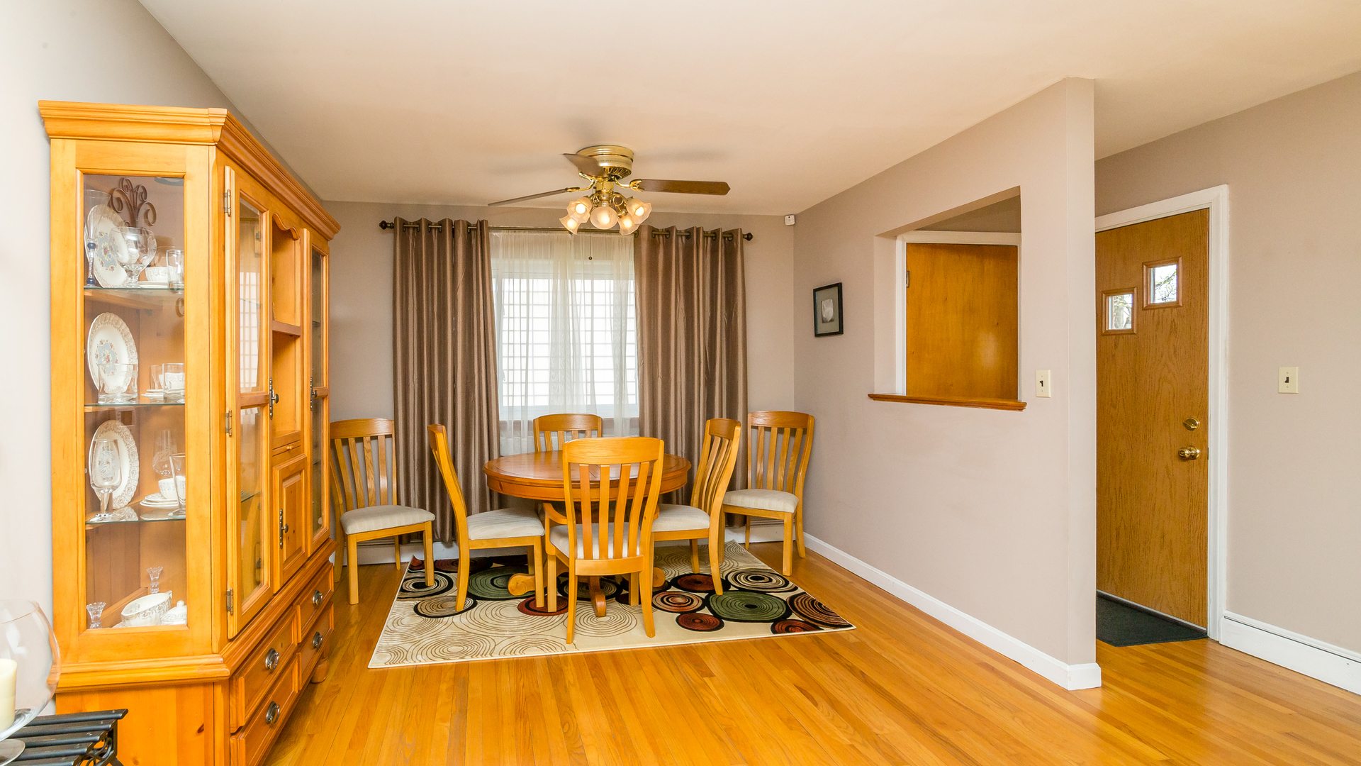 718 Spring Road Elmhurst, IL 60126 - Photo 8 of 34 a view of a dining room with furniture and wooden floor