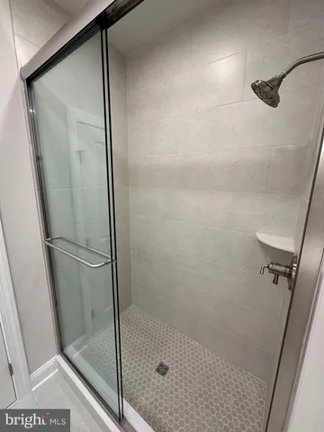 a bathroom with a glass shower door
