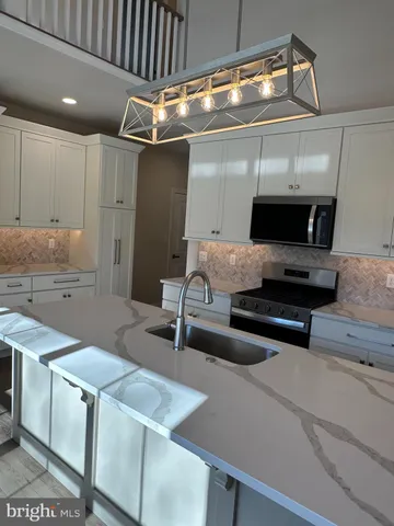 a kitchen with a sink appliances and cabinets