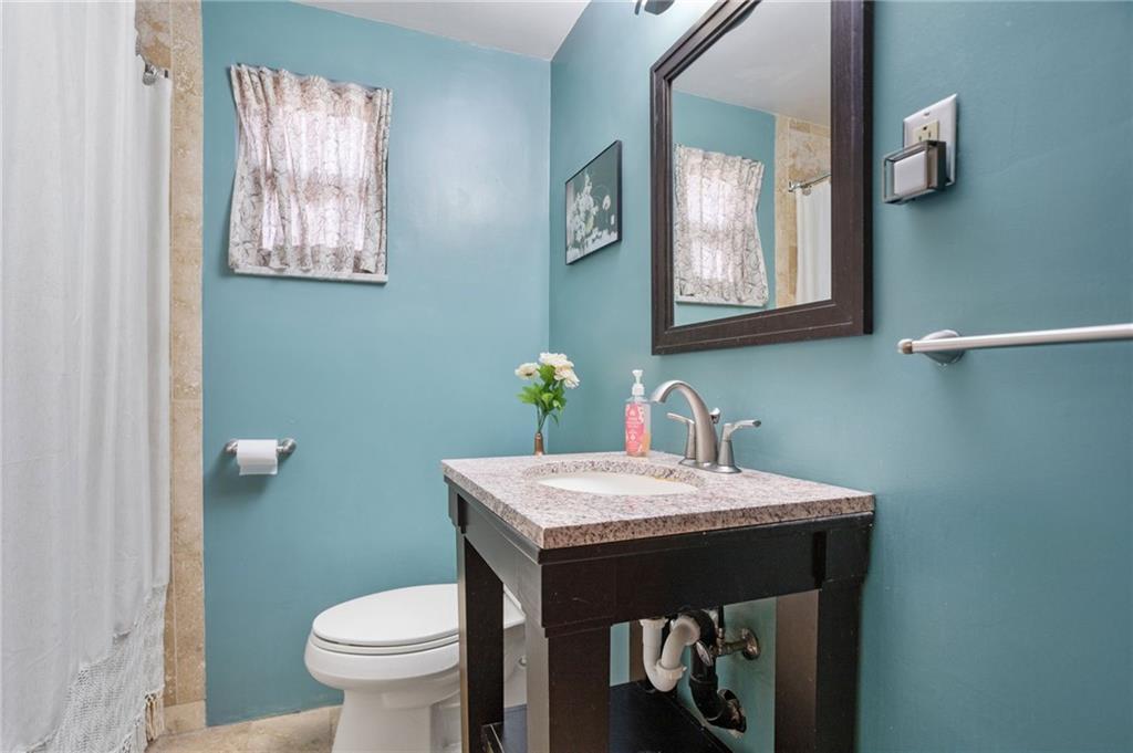 314 Rockfield Road Pittsburgh, PA 15243 - Photo 17 of 21 a bathroom with a sink a toilet and mirror