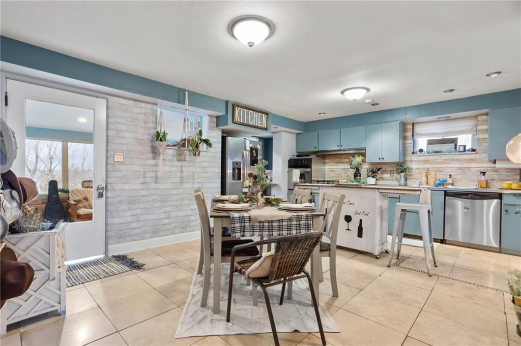 314 Rockfield Road Pittsburgh, PA 15243 - Photo 6 of 21 a room with stainless steel appliances kitchen island granite countertop a stove a sink a dining table and chairs