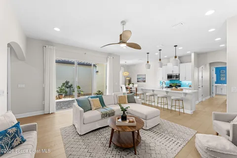 a living room with furniture and a wooden floor