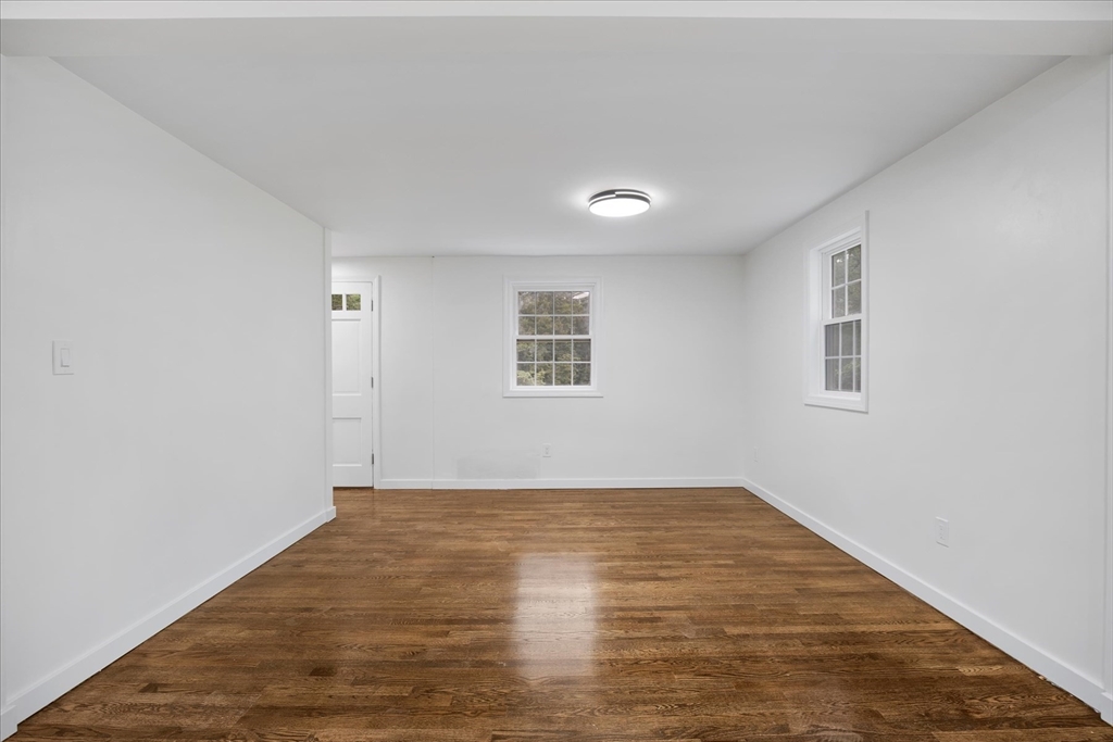 34 Carleton Road Hingham, MA 02043 - Photo 11 of 35 an empty room with wooden floor and windows