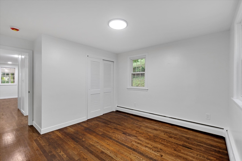 34 Carleton Road Hingham, MA 02043 - Photo 18 of 35 an empty room with wooden floor and windows