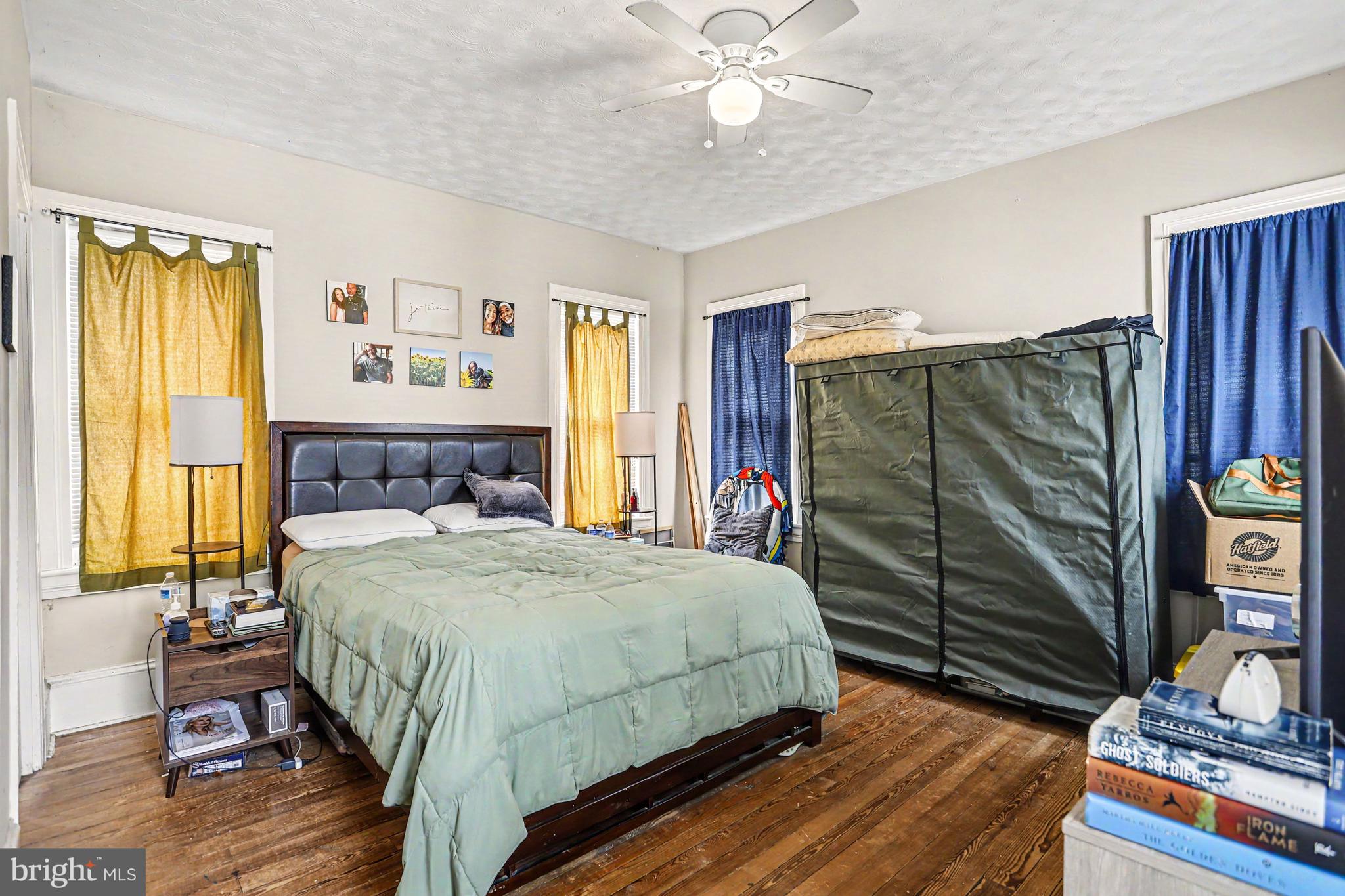 23 West George Street Yoe, PA 17313 - Photo 14 of 36 a bedroom with a bed and a chandelier