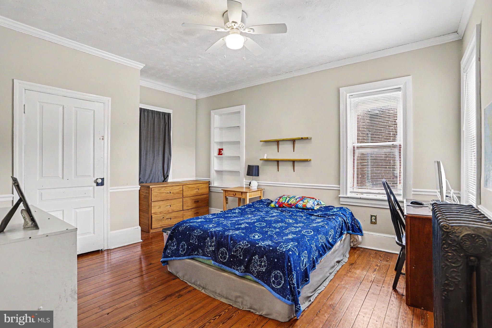 23 West George Street Yoe, PA 17313 - Photo 16 of 36 a bedroom with a bed and wooden floor
