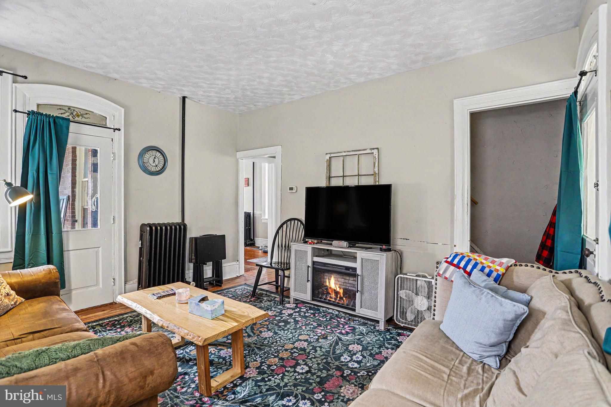 23 West George Street Yoe, PA 17313 - Photo 8 of 36 a living room with furniture and a flat screen tv