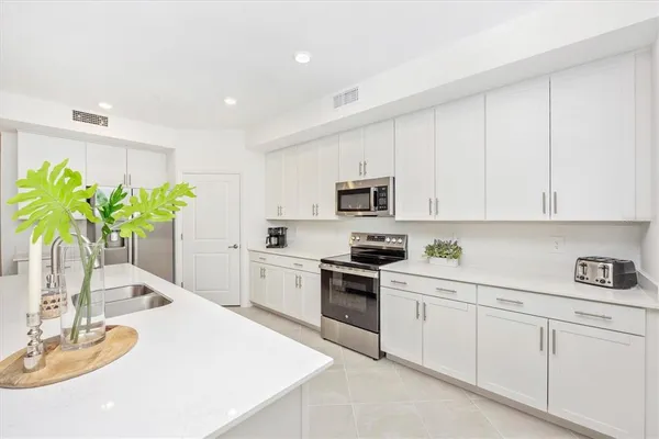 a living room with furniture a flat screen tv and a large window