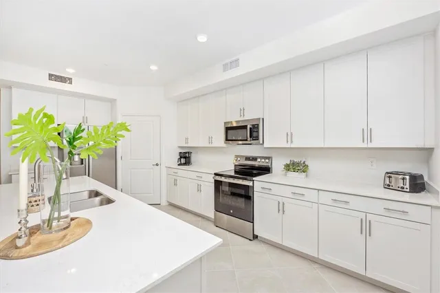 a living room with furniture a flat screen tv and a large window