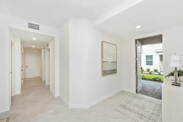 a kitchen with stainless steel appliances kitchen island granite countertop a table chairs sink and cabinets
