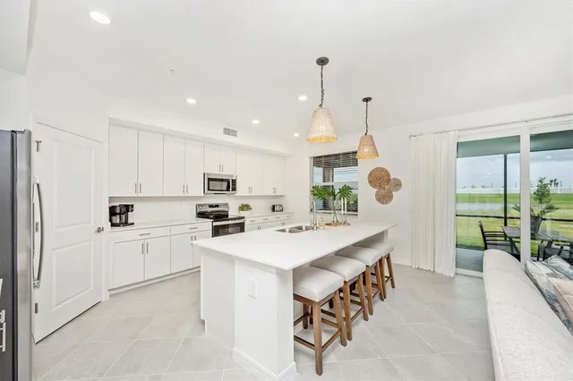 a kitchen with a sink stove and refrigerator