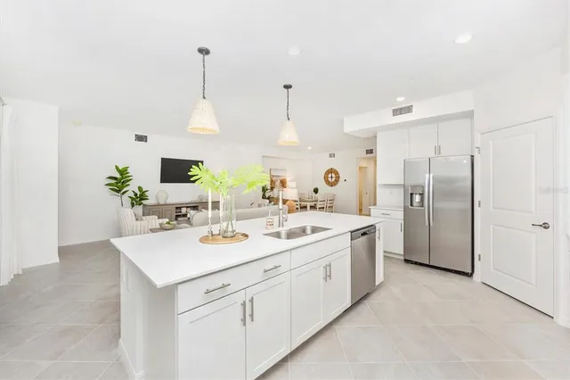 a view of a dining room with furniture and a potted plant