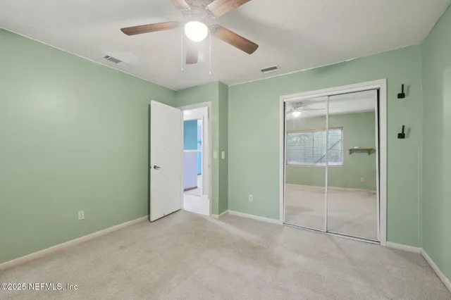 a view of an empty room with a fan