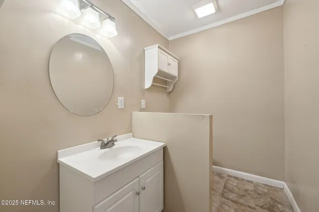 a bathroom with a sink mirror and vanity