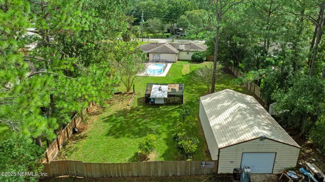 an aerial view of a house with a yard