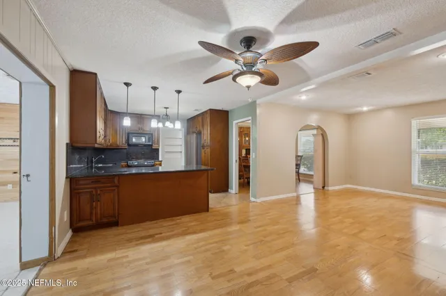 a view of a kitchen with a sink and stainless steel appliances