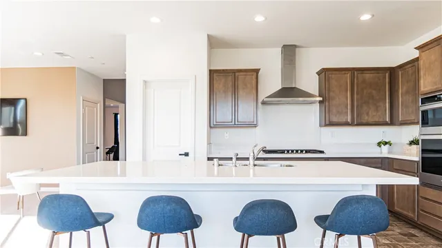 a kitchen with stainless steel appliances a sink a table and chairs