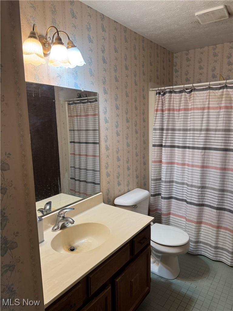 4015 Marks Road, Unit 1A Medina, OH 44256 - Photo 9 of 9 Bathroom with tile patterned floors, vanity, toilet, and a textured ceiling