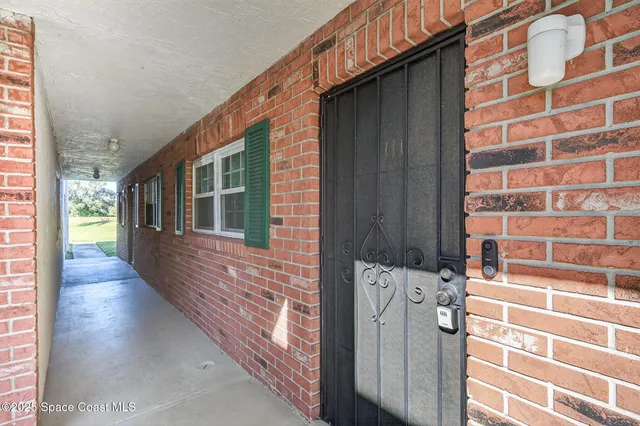 a kitchen with a refrigerator and a stove with wooden floor