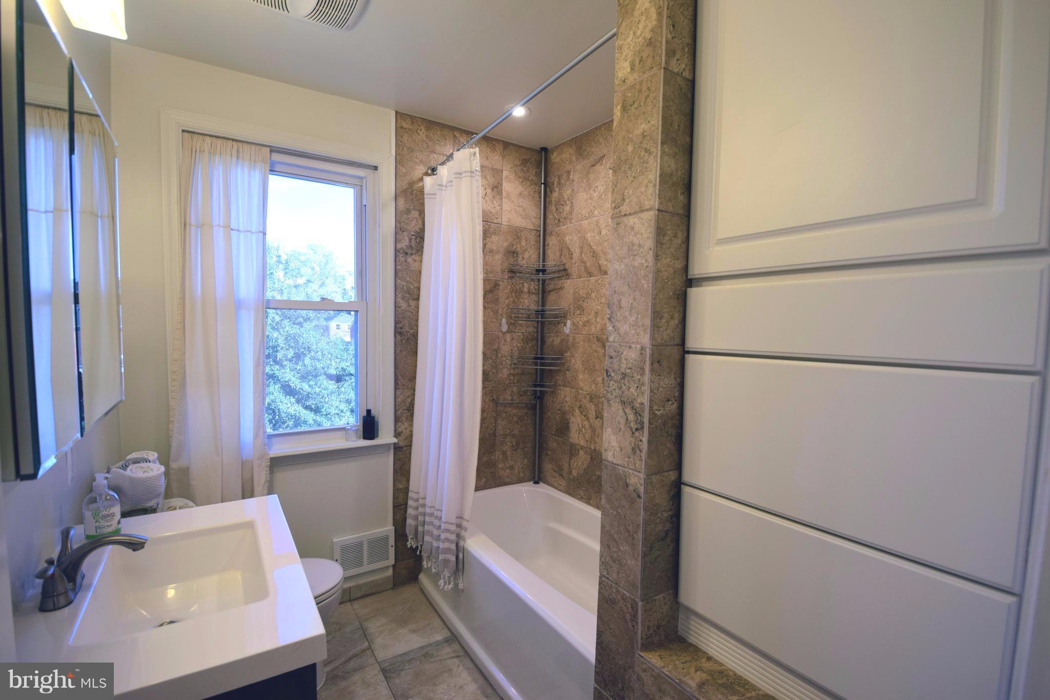 8536 Water Oak Road Baltimore, MD 21234 - Photo 14 of 27 a bathroom with a bathtub and a shower