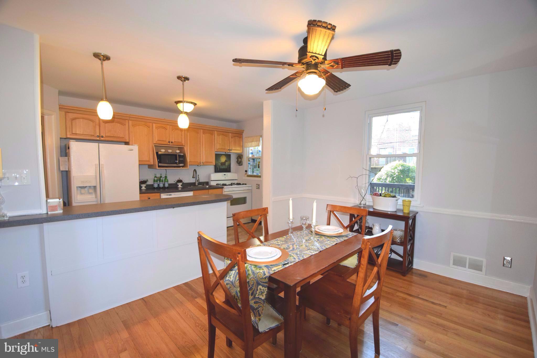 8536 Water Oak Road Baltimore, MD 21234 - Photo 7 of 27 a view of a dining room with furniture and wooden floor