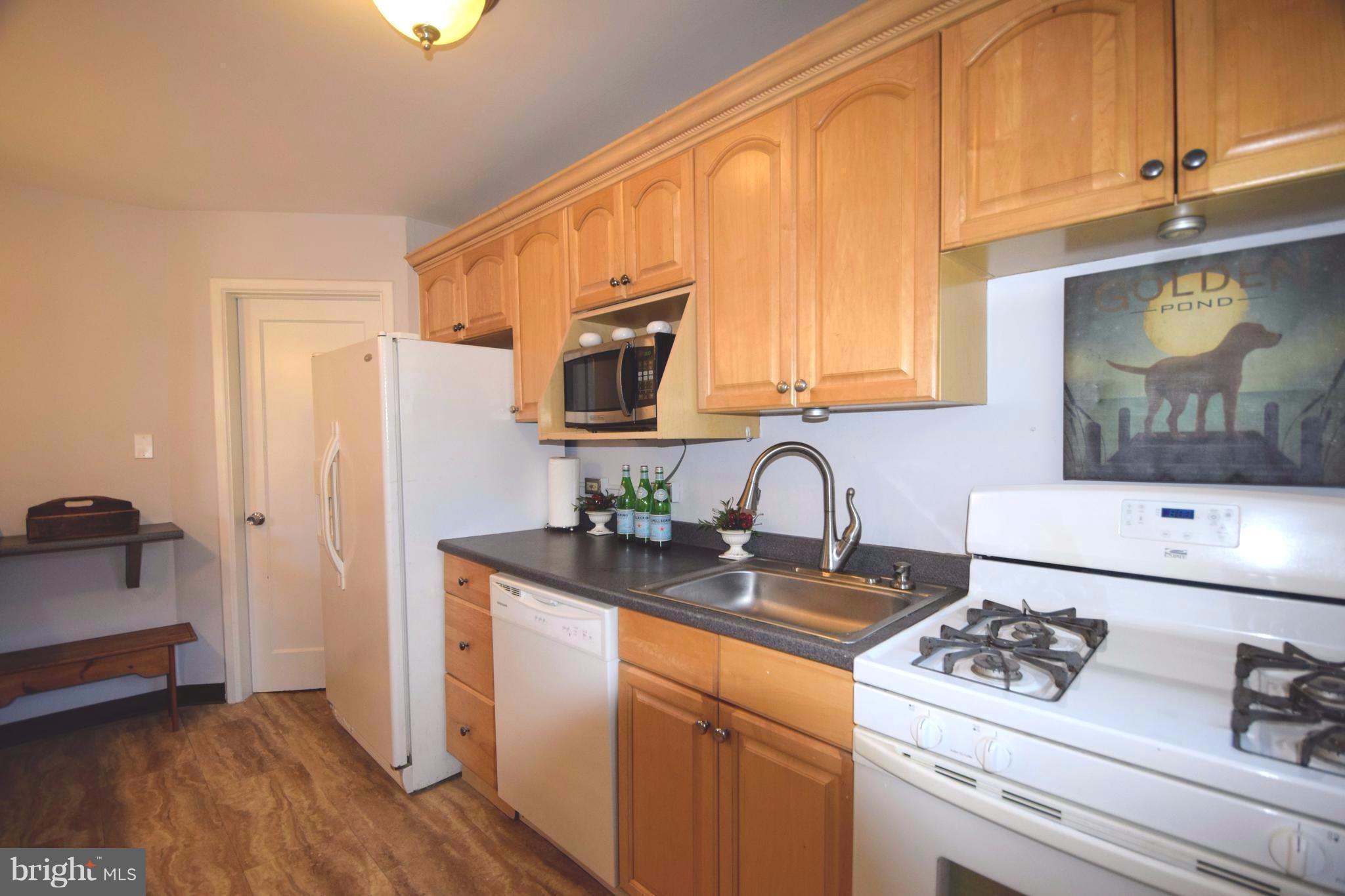 8536 Water Oak Road Baltimore, MD 21234 - Photo 9 of 27 a kitchen with stainless steel appliances granite countertop a sink stove and cabinets