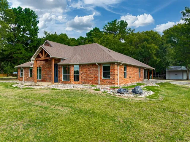 a aerial view of a house with swimming pool next to a yard