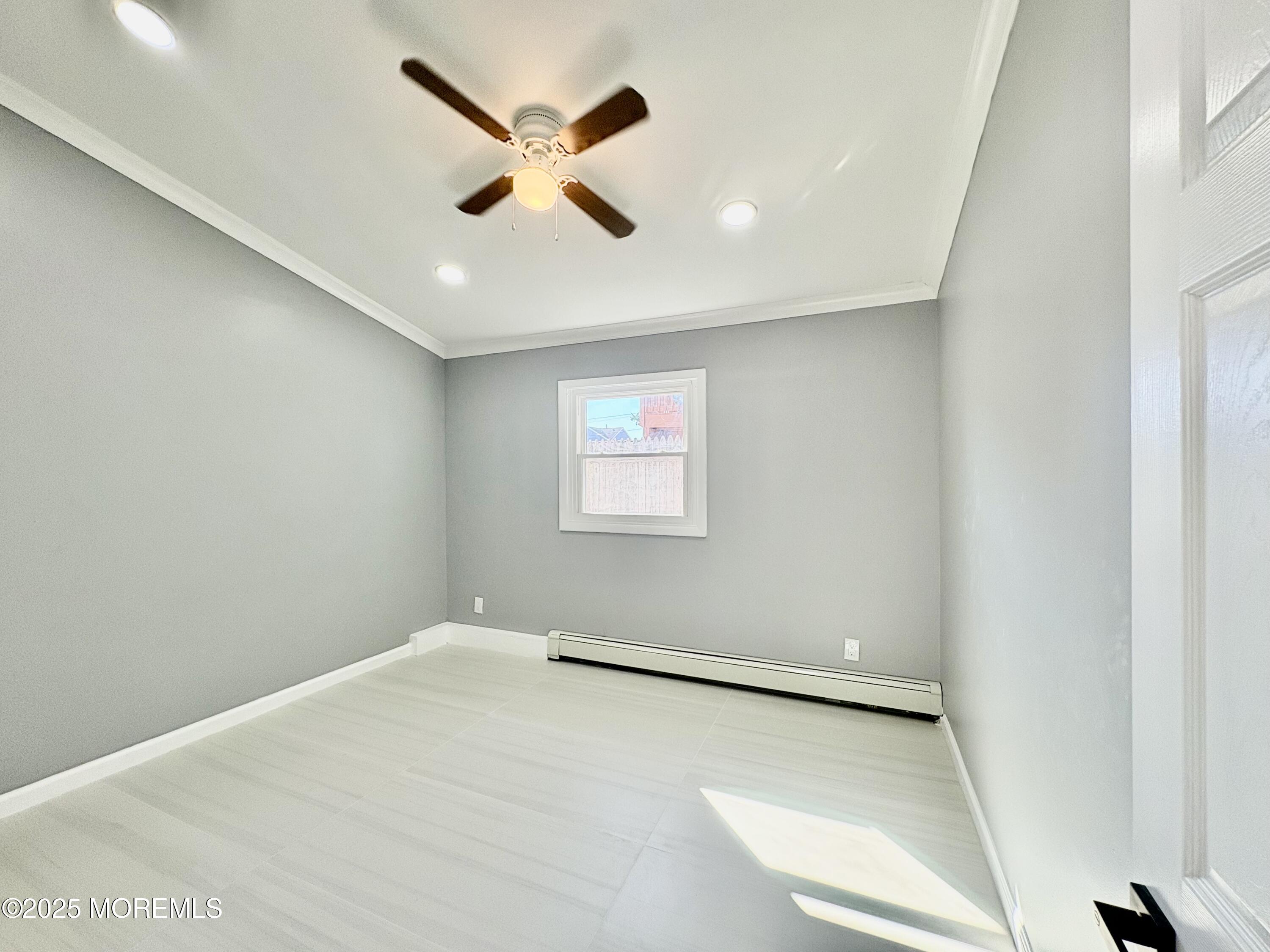 1712 Binnacle Road Forked River, NJ 08731 - Photo 4 of 9 an empty room with windows and fan