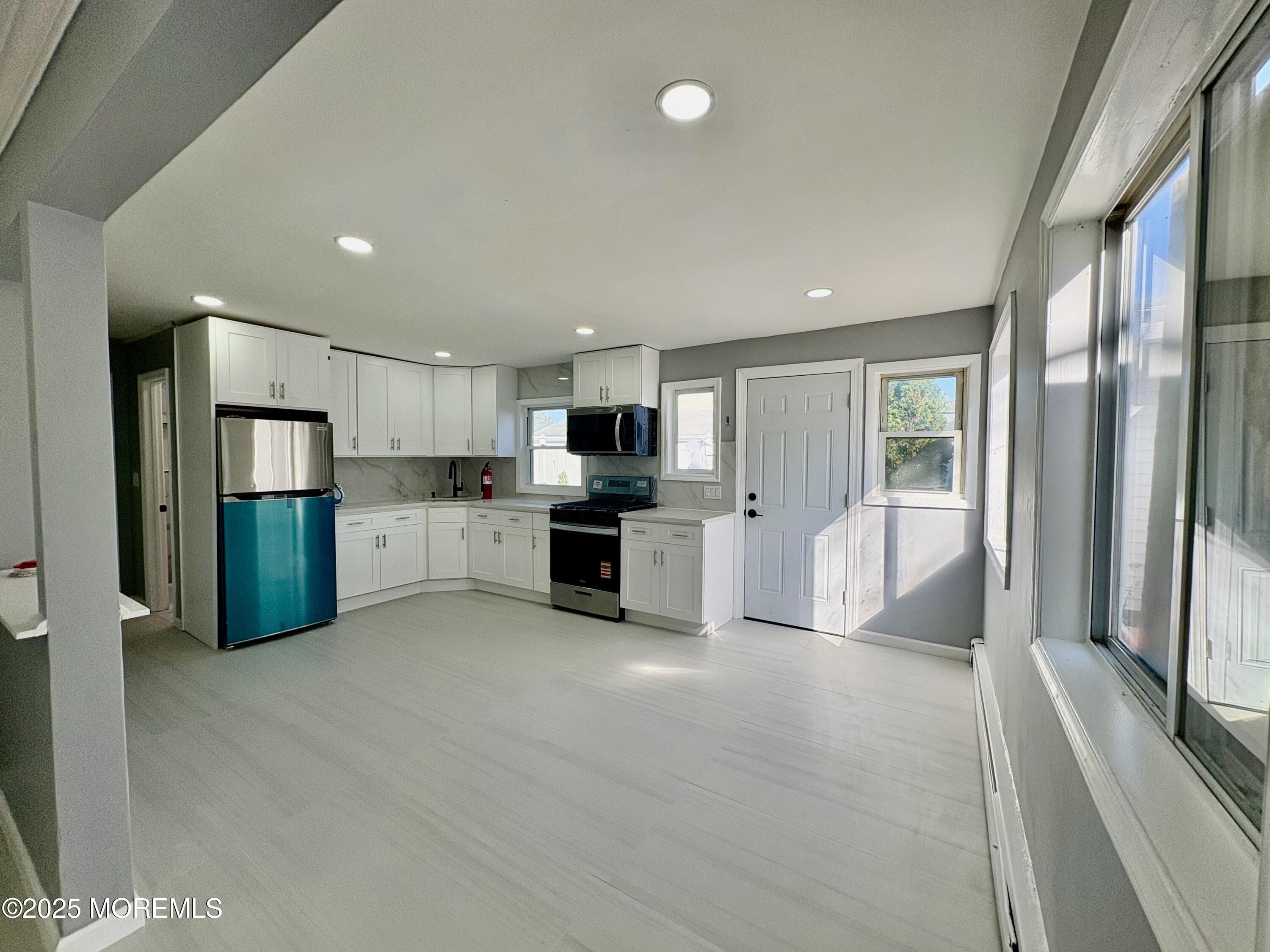 1712 Binnacle Road Forked River, NJ 08731 - Photo 5 of 9 a large white kitchen with stainless steel appliances granite countertop a refrigerator and a stove top oven