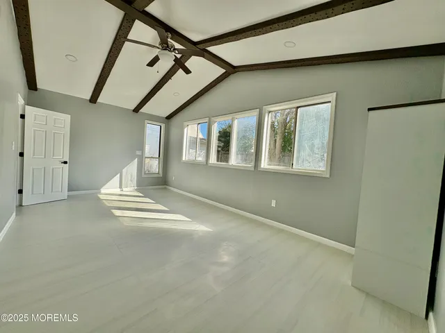 a view of a kitchen with a refrigerator a microwave and a sink